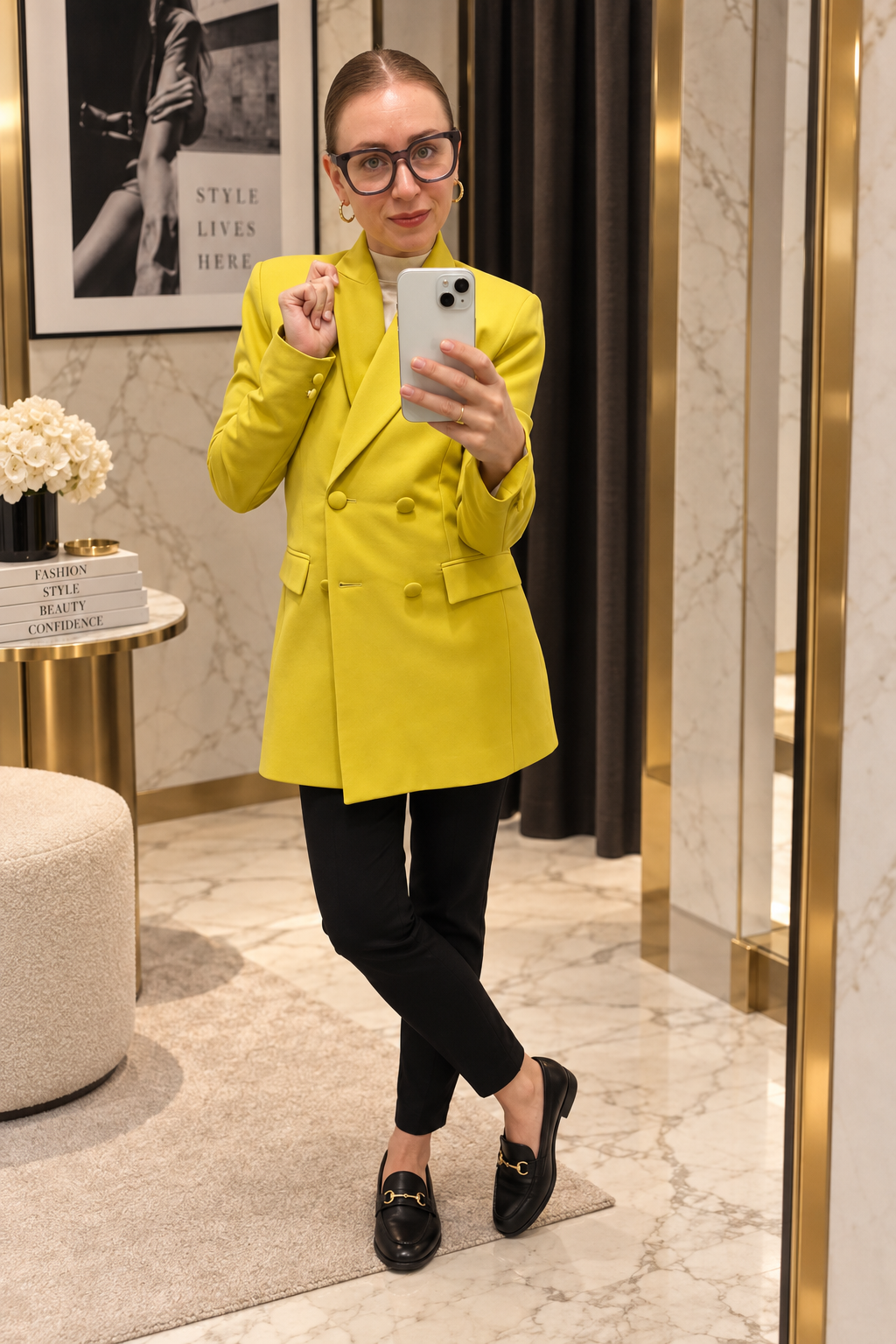 Tina Serfontein in a tailored citrus blazer in a mirrored fitting room